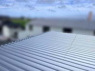 倉庫折板屋根の重ね葺き工事が完了した
